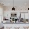 White modern cabinetry and pendant lighting in Church + State Apartments Kitchens